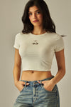 Cream cotton blend crop top featuring a playful cherry print, perfect for casual Long Island boutique fashion styling.