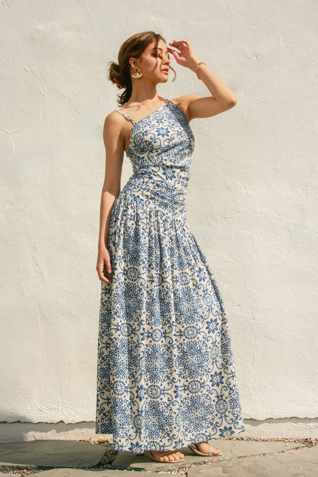 One-shoulder Azalea Mosaic Dress featuring a flowing, maxi silhouette in cream with intricate blue floral patterns, perfect for Long Island boutique fashion.