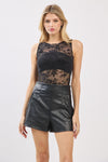 Sleeveless black flocked bodysuit with floral detailing, paired with high-waisted leather shorts, perfect for Long Island boutique fashion.