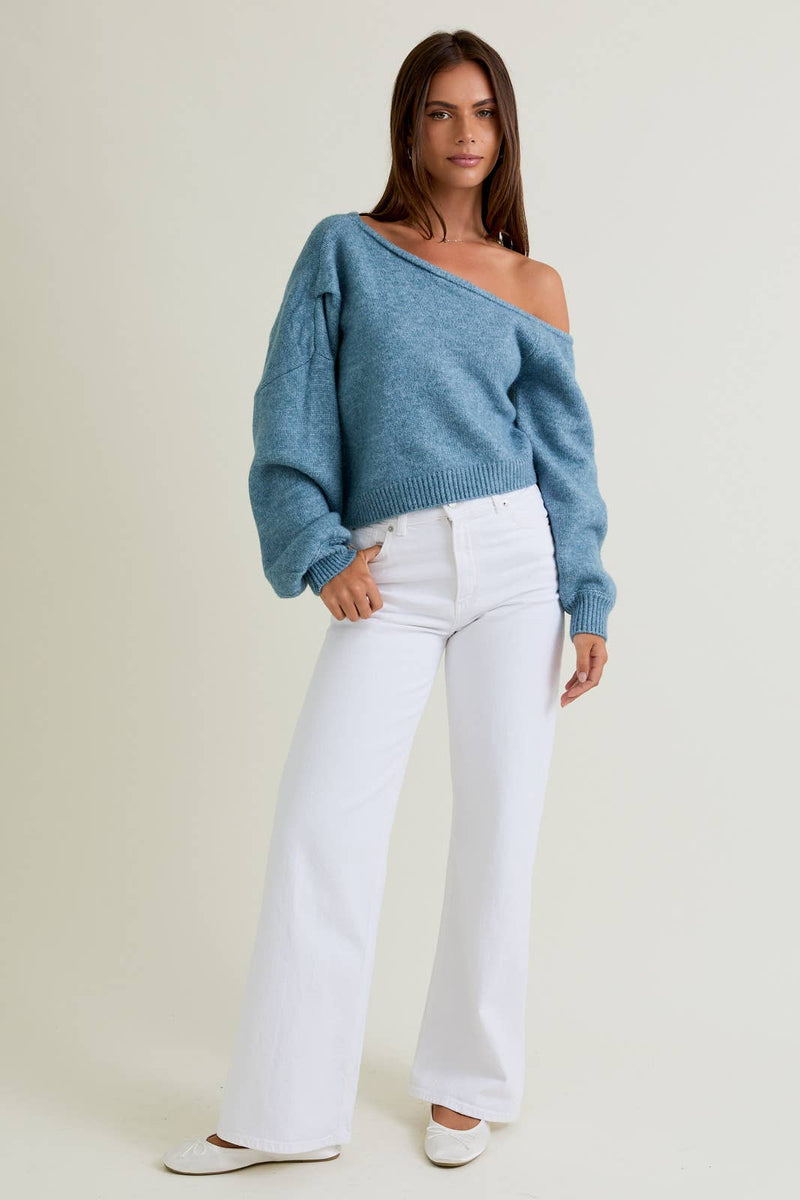 Soft blue asymmetrical shoulder sweater top with loose fit and balloon sleeves, perfect for Long Island boutique fashion styling.