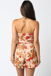Strapless floral romper featuring earthy tones and a ruffled hem, perfect for warm days in Long Island boutique fashion.