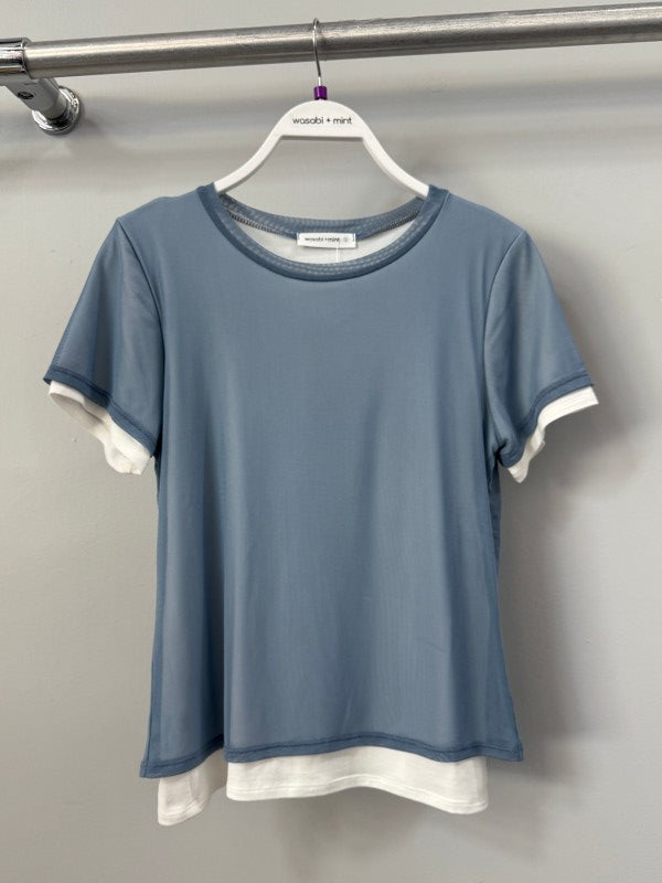 Close-up of mesh overlay layered tee in dark denim