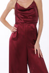 Elegant burgundy satin jumpsuit featuring a cowl neck and backless design, perfect for a night out in Long Island boutique fashion.
