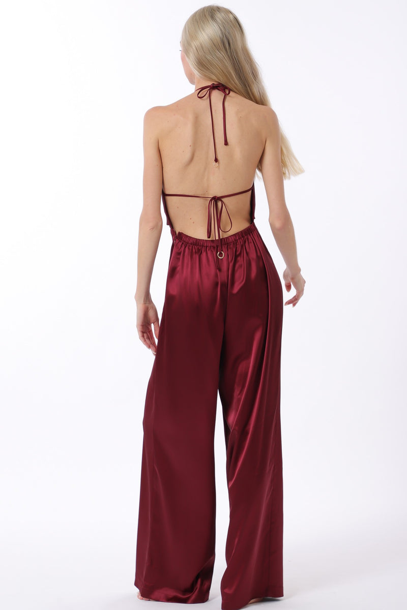Backless cowl neck jumpsuit in rich burgundy satin, featuring wide-leg pants and adjustable ties, perfect for Long Island boutique fashion.