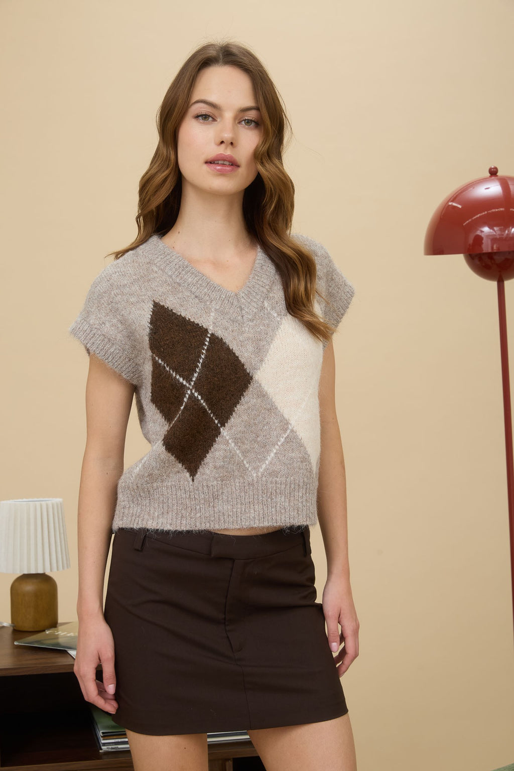 Sleeveless argyle pattern V-neck sweater vest in soft beige, brown, and cream tones, perfect for Long Island boutique fashion layering.