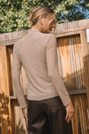 Elegant embellished mock neck top in neutral tones, featuring a fitted silhouette with subtle shimmer, perfect for Long Island boutique fashion.