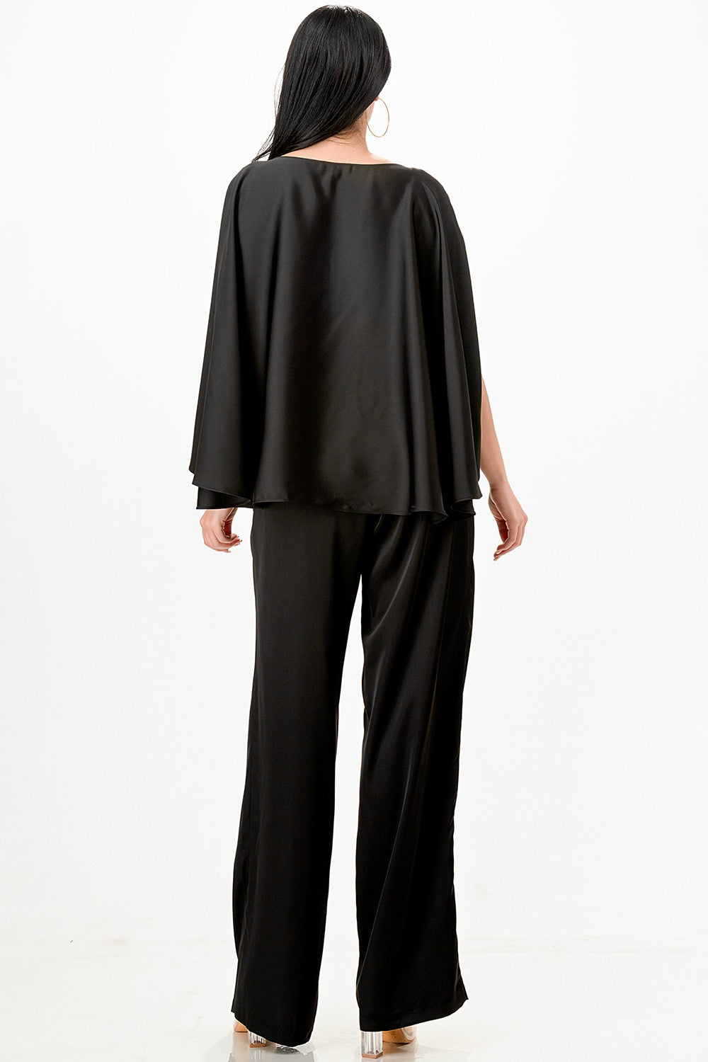 Stylish black draped cape top paired with wide-leg pants features elegant detailing, perfect for Long Island boutique fashion.