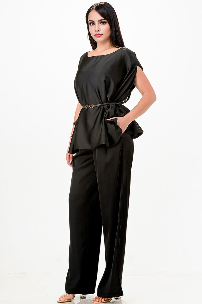 Sleek black draped cape top paired with wide-leg pants, featuring a stylish belt and pockets, ideal for chic Long Island boutique fashion.