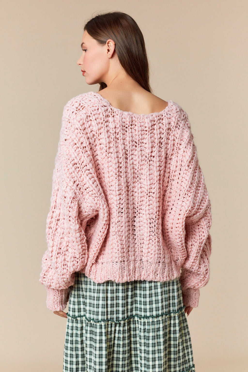 Model wearing Popcorn Yarn V-Neck Cropped Sweater in light pink — chunky knit texture with relaxed fit, available at TandyWear Boutique in Commack, NY. front view 