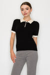 Short-sleeve black collar sweater top with cream trim and button detail, perfect for a chic style in Long Island boutique fashion.