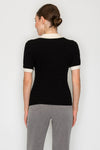Short-sleeve black collar sweater top with textured knit detail and contrasting cream trim, perfect for a chic Long Island boutique fashion look.