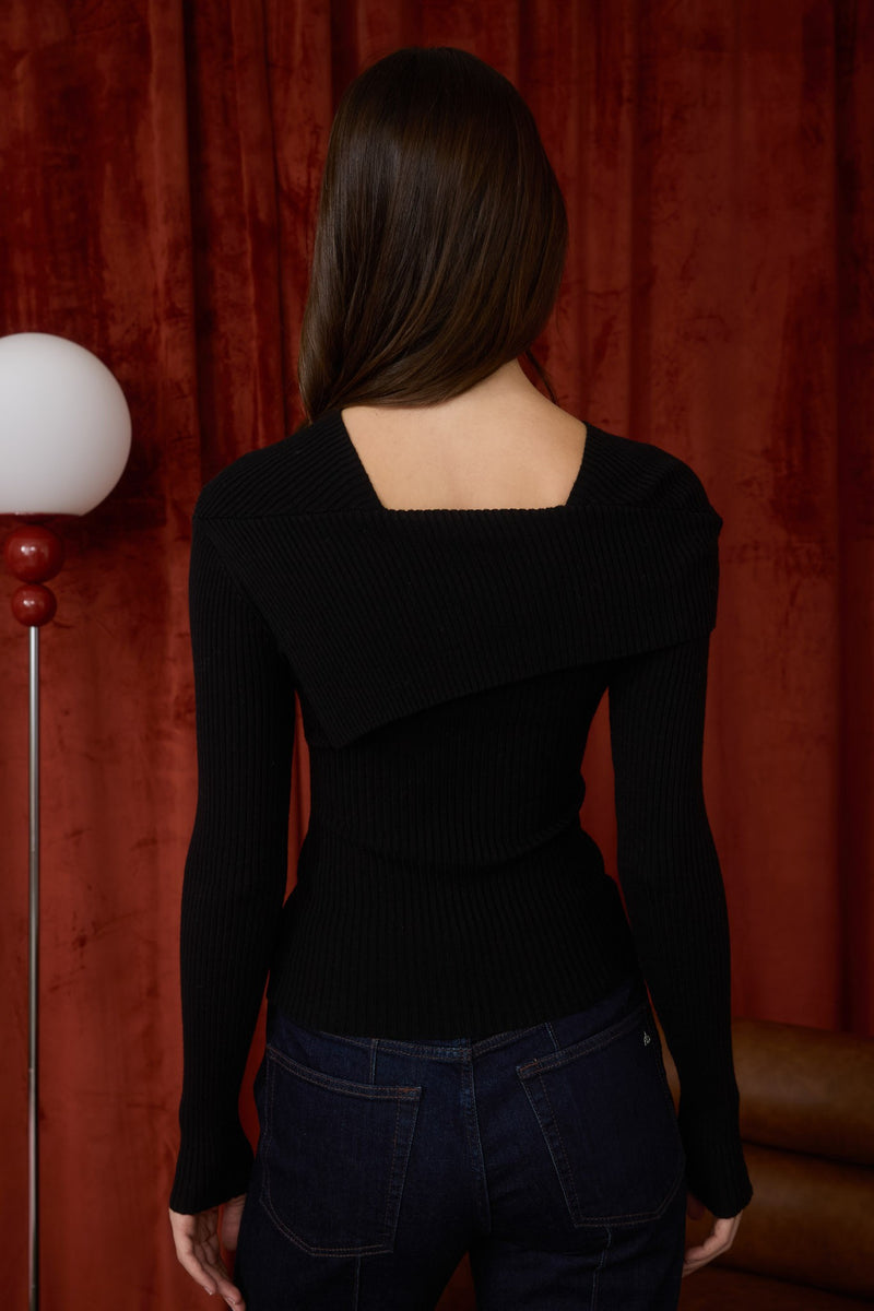 A sleek black asymmetrical fold-over long sleeve sweater with a ribbed texture, perfect for Long Island boutique fashion.