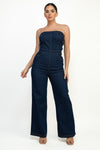 Strapless elastic tube jumpsuit in dark denim with wide leg design and contrasting stitching, perfect for Long Island boutique fashion.