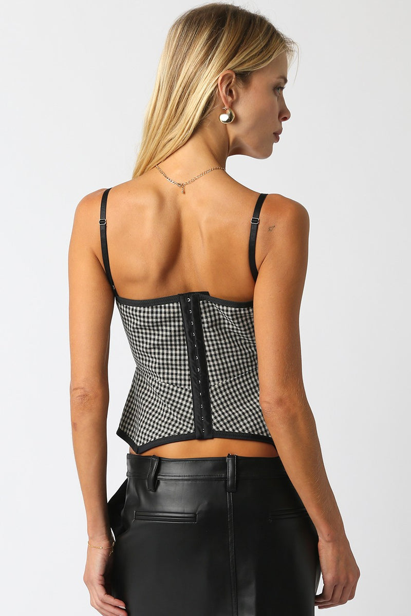 Black and white gingham top with a fitted silhouette, adjustable straps, and a flattering hook closure, perfect for Long Island boutique fashion.
