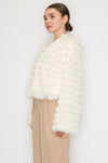 Soft, shaggy faux fur jacket in cream with a cropped fit and wide sleeves, perfect for adding warmth to any outfit in Long Island boutique fashion.