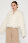 Soft cream faux fur shaggy jacket with a cropped fit and textured fringe, perfect for layering in Long Island boutique fashion.