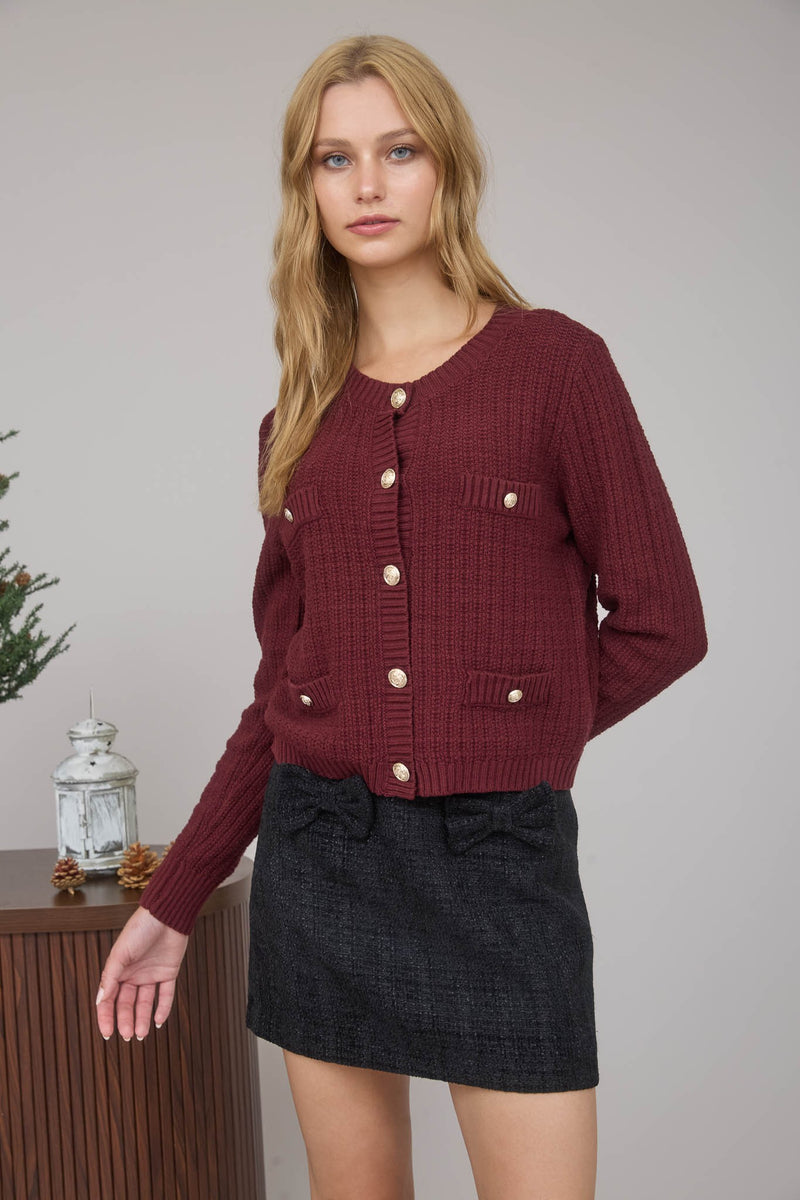 Textured burgundy cardigan featuring gold buttons and pocket details, perfect for stylish layering in Long Island boutique fashion.