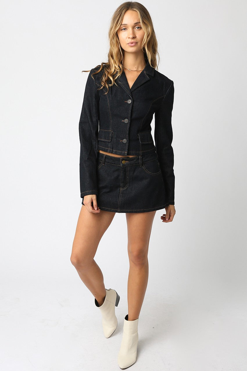 Model wearing Emely Denim Skort in dark wash — high-rise mini skort with tailored seams, available at TandyWear Boutique in Commack, NY. front view