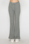 Soft gray elastic wide-leg pants with a comfortable drawstring waistband, perfect for relaxed outfits in Long Island boutique fashion.