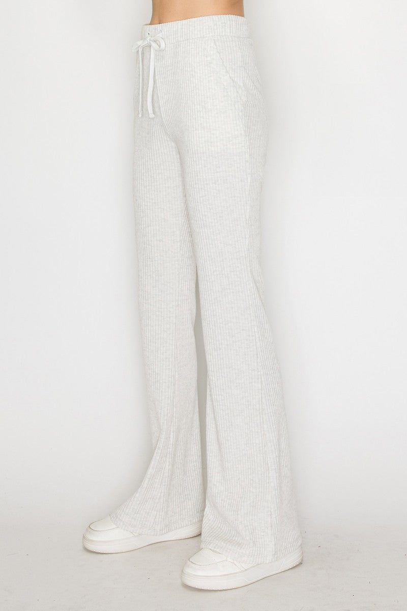 Soft gray elastic wide leg pants featuring a comfortable drawstring waist and subtle ribbed texture, perfect for Long Island boutique fashion.