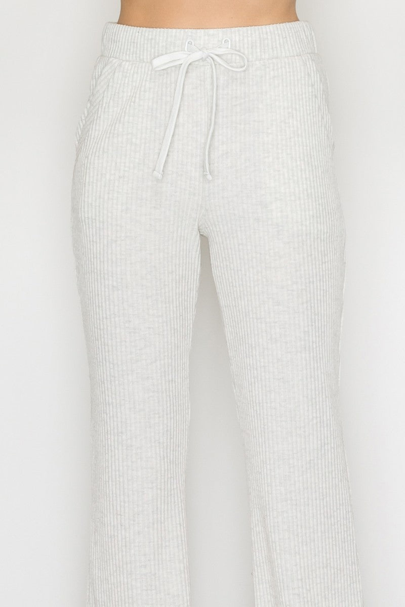 Light grey elastic wide leg pants featuring a soft ribbed texture and adjustable drawstring waistband, perfect for Long Island boutique fashion.