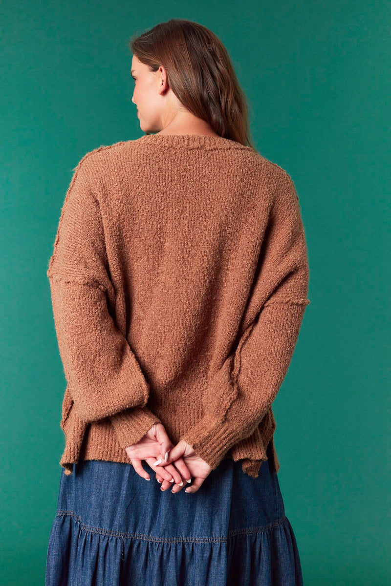 Model wearing Gingerbread Man Oversized Sweater in brown — soft fuzzy knit with large gingerbread graphic, available at TandyWear Boutique in Commack, NY. back view