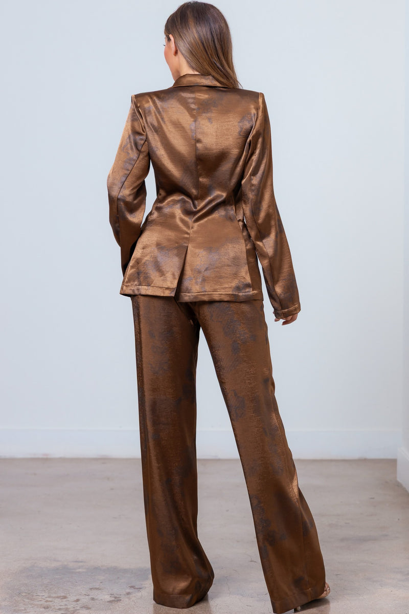 This floral print blazer jacket and pants set in a rich bronze hue offers a sophisticated, tailored silhouette perfect for Long Island boutique fashion.
