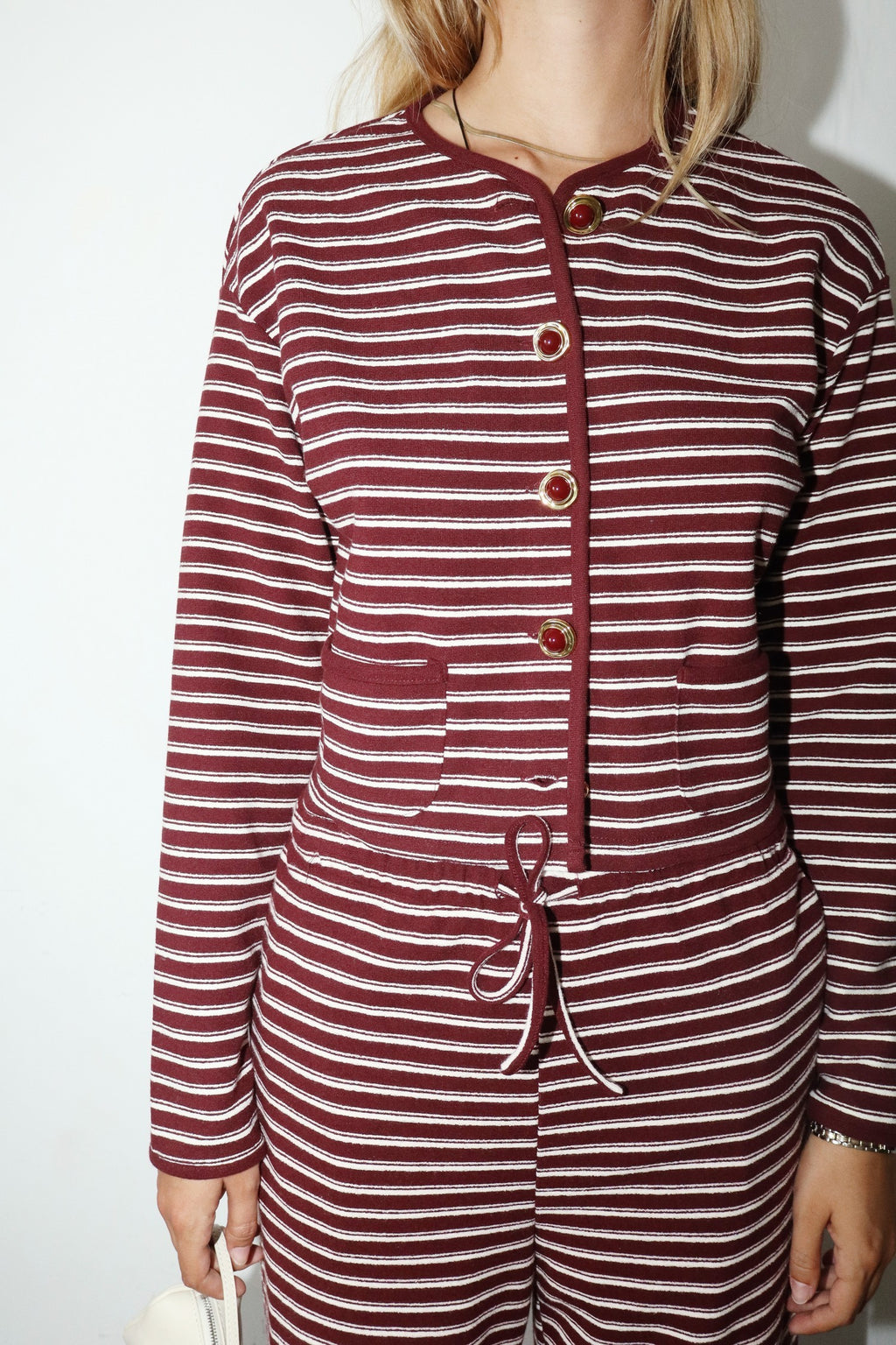 “Striped cropped button up knit jacket on model”
