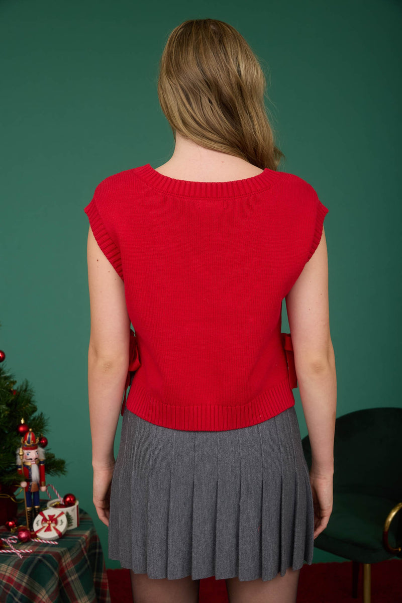 Red cable knit V-neck sweater vest with a stylish side tie, perfect for layering in Long Island boutique fashion.