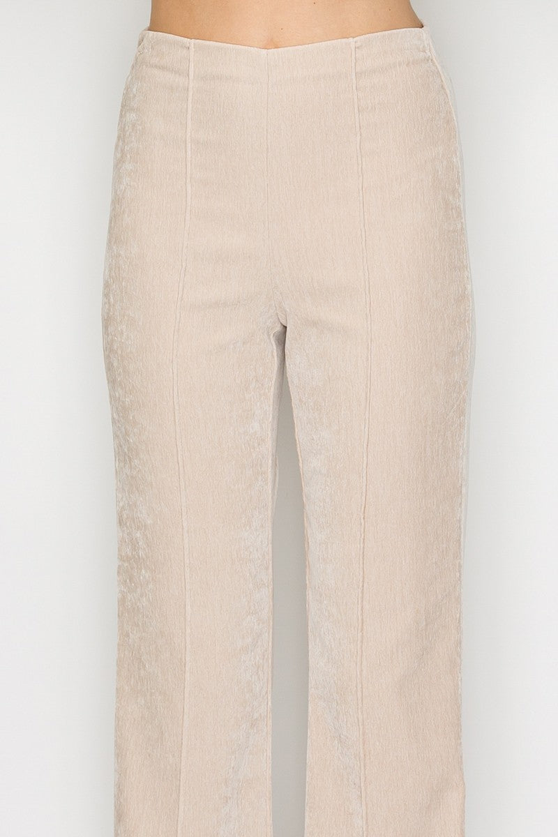Light beige fit and flare pants featuring a smooth texture and tailored fit, perfect for Long Island boutique fashion.