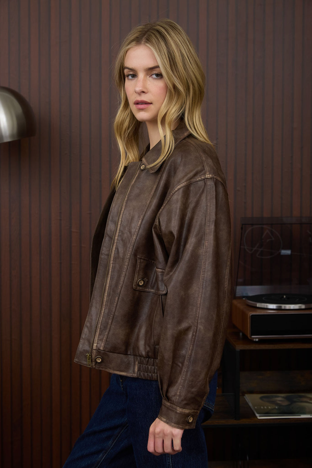 Brown collared zip-up washed faux leather jacket with a relaxed fit and side pockets, a stylish choice from a Long Island women's boutique.