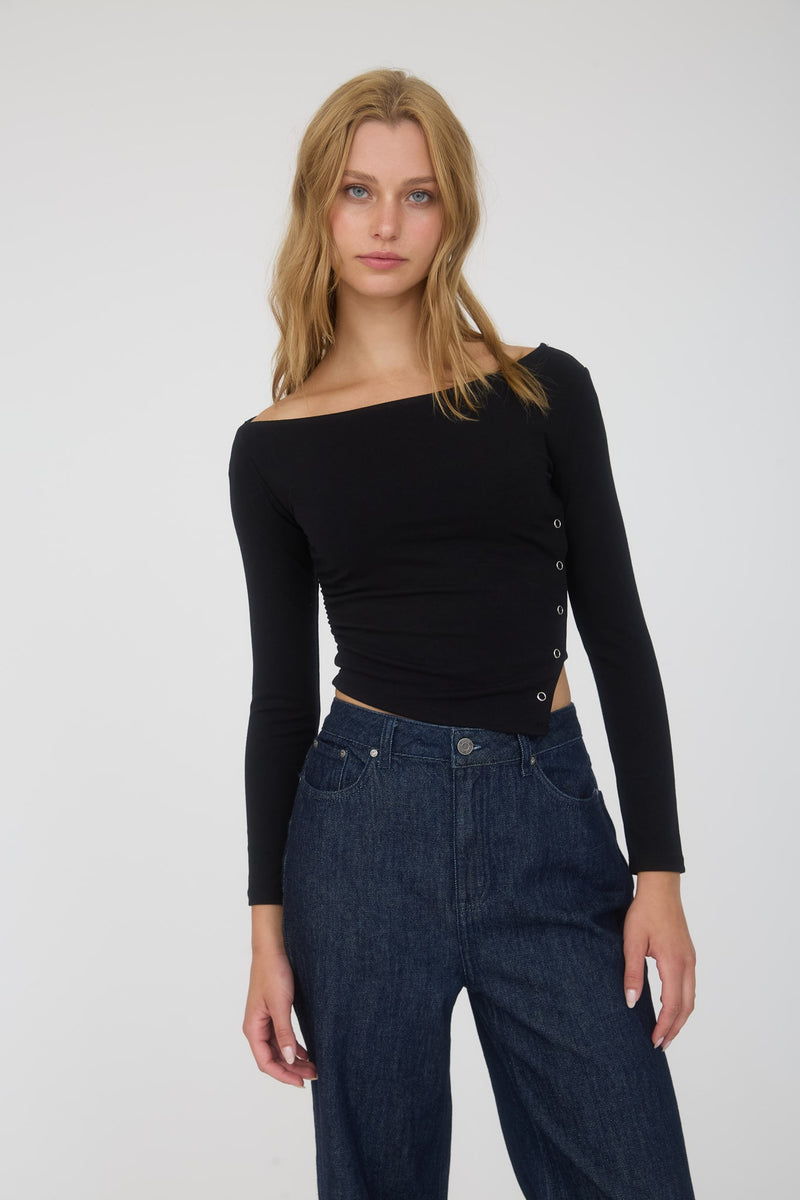 Black asymmetrical long sleeve crop top featuring snap button details, perfect for casual chic looks at a Long Island boutique fashion.