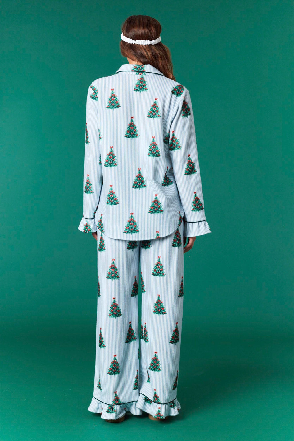 Model wearing Striped Christmas Tree Pajama Set in light blue with festive tree print — button-front top and relaxed pants, available at TandyWear Boutique in Commack, NY. front view 