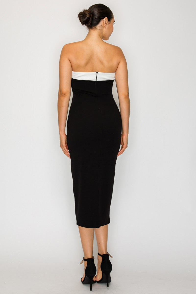 Strapless black capri dress with a contrasting white bodice, tailored fit, and sleek mid-length design, perfect for Long Island boutique fashion.