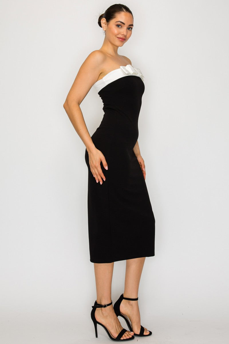 Strapless black tube dress featuring a white bow detail at the neckline, perfect for Long Island boutique fashion styling.