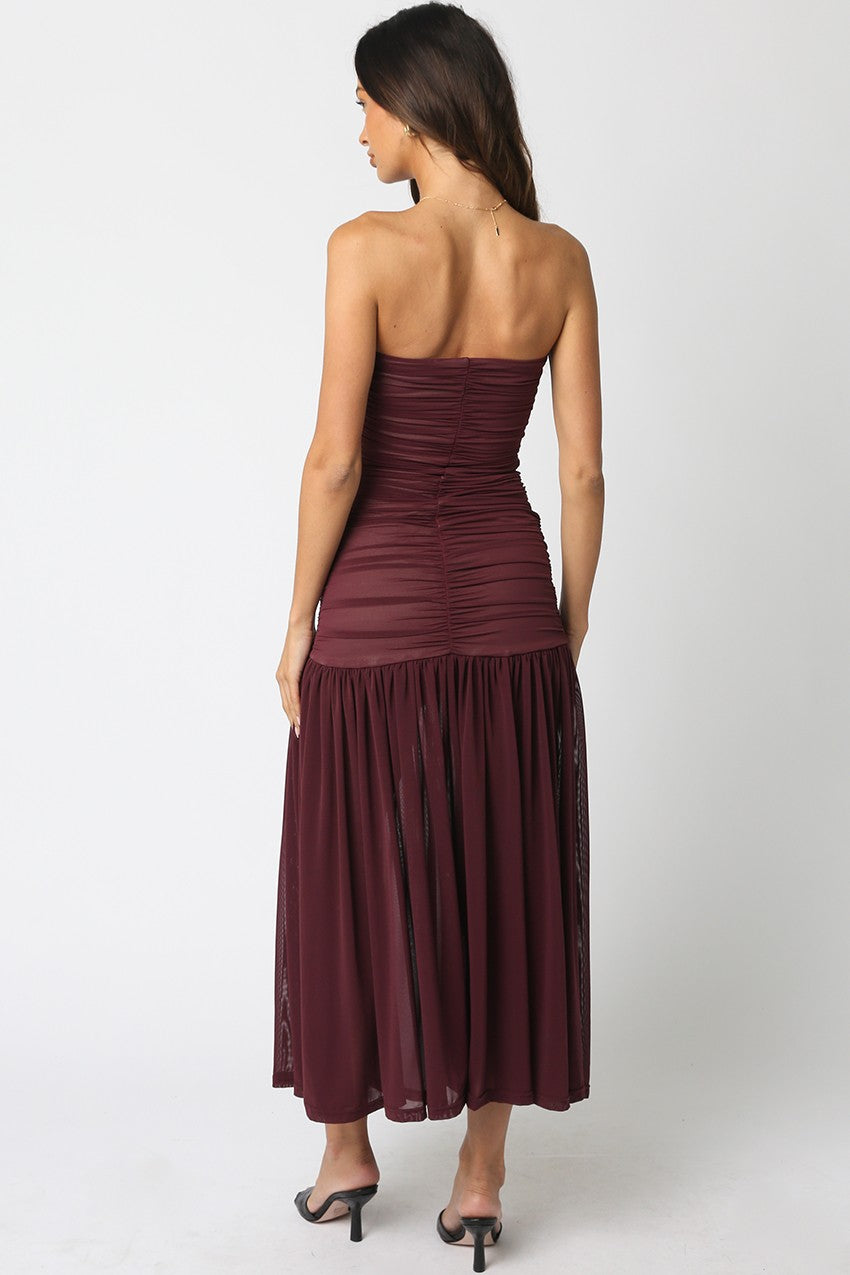Strapless, burgundy maxi dress with a fitted bodice and flowy skirt, perfect for a stylish outing in Long Island boutique fashion.