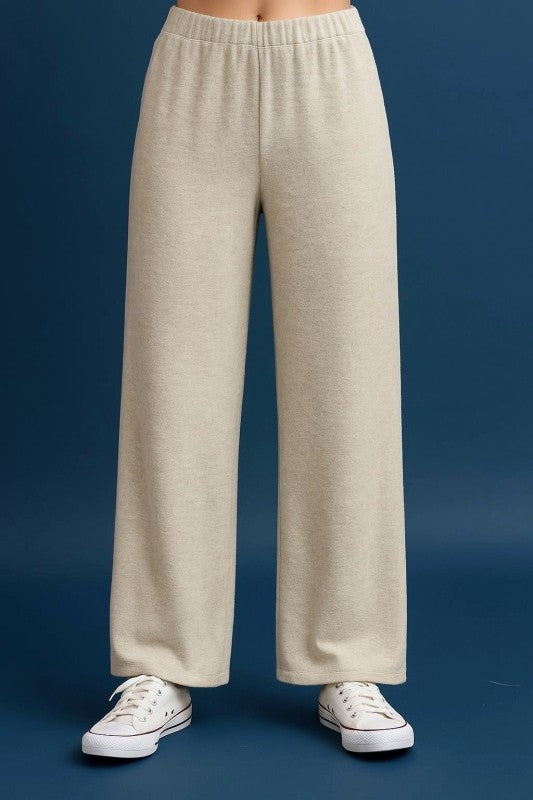 Soft, beige cashmere brushed wide leg pants featuring an elastic waistband, perfect for cozy, stylish looks in Long Island boutique fashion.