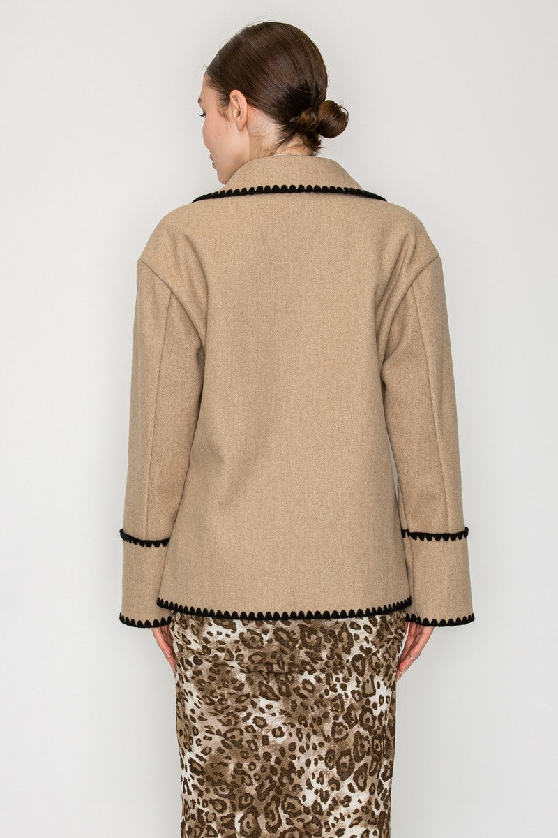 A stylish double-breasted jacket in a warm taupe hue, featuring a blanket stitch trim and a relaxed fit, perfect for Long Island boutique fashion.