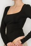 Women’s black square neck long sleeve bodysuit — fitted stretch knit with snap closure, sleek minimalist top available at TandyWear Off Price, Commack NY. full bodysuit view 