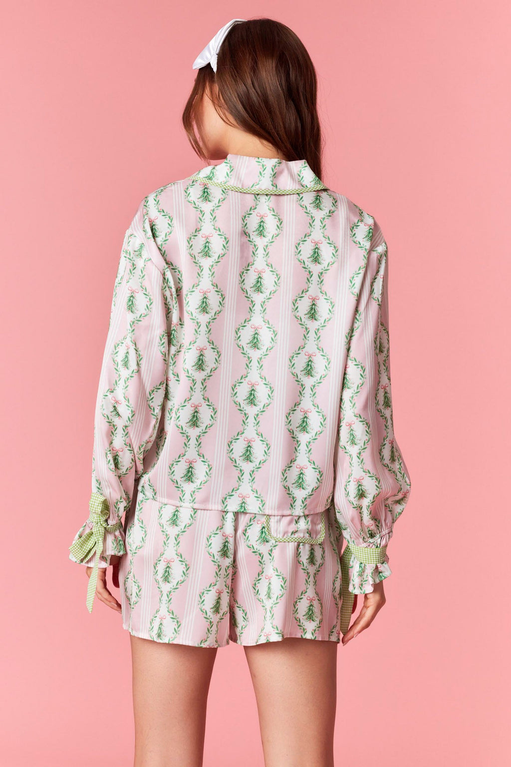 Model wearing Christmas Satin Gingham PJ Short Set in baby pink and light green — satin two-piece holiday sleepwear with bow tie waist, available at TandyWear Boutique in Commack, NY. front view