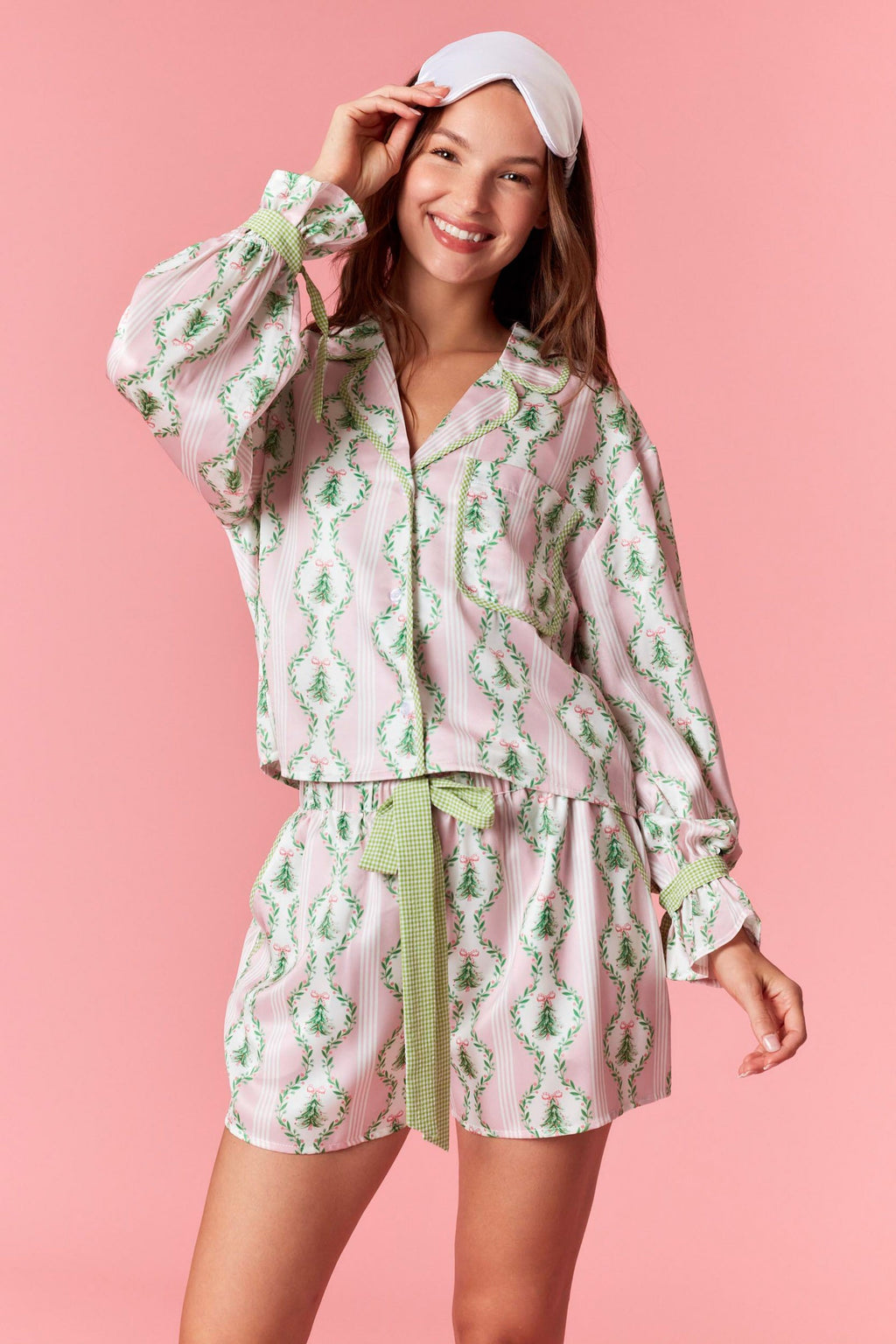 Model wearing Christmas Satin Gingham PJ Short Set in baby pink and light green — satin two-piece holiday sleepwear with bow tie waist, available at TandyWear Boutique in Commack, NY. front view