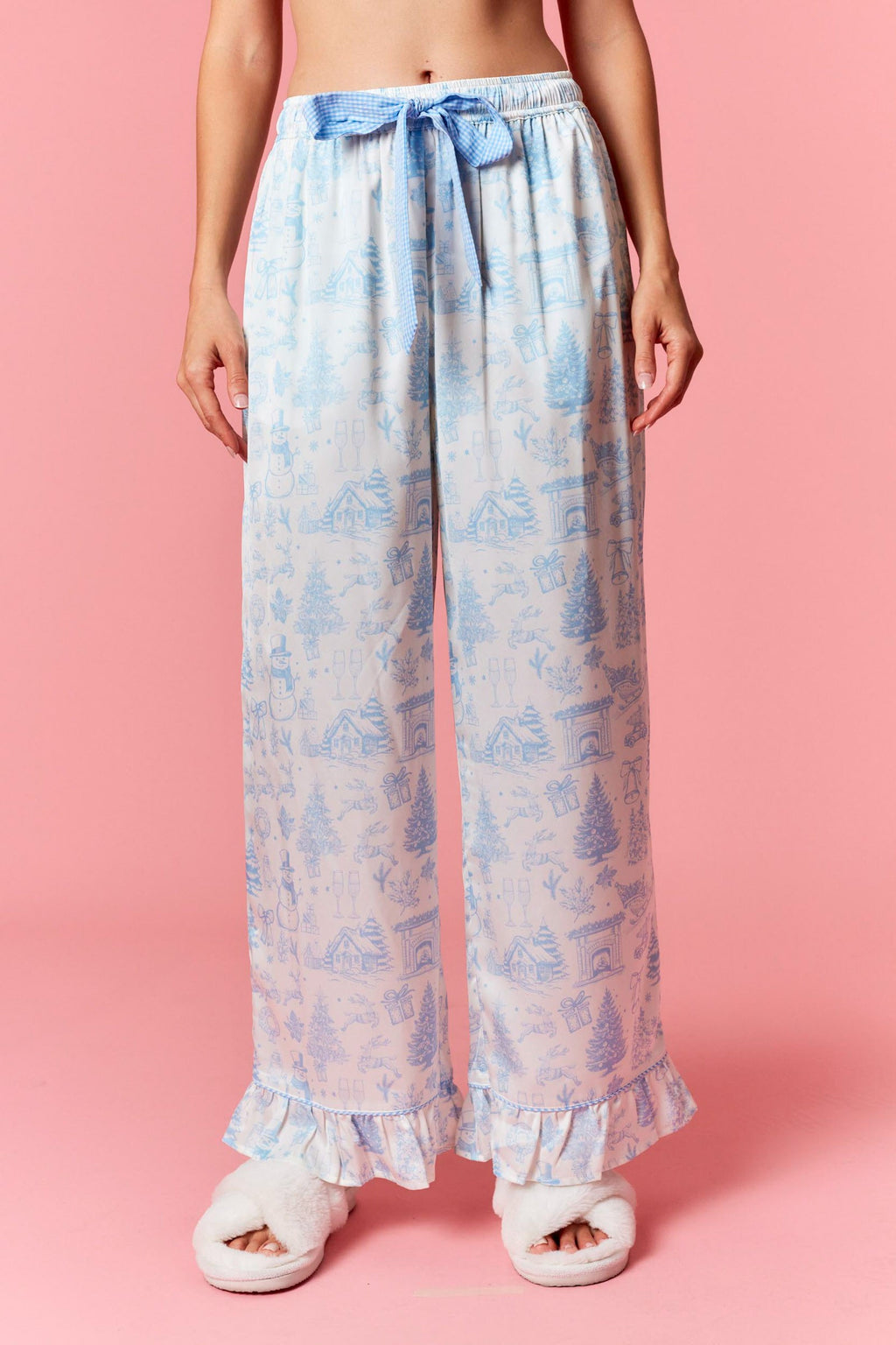 Model wearing Christmas Satin Gingham Pajama Set in light blue — silky satin button-up top and matching pants with gingham ties, available at TandyWear Boutique in Commack, NY. front view 