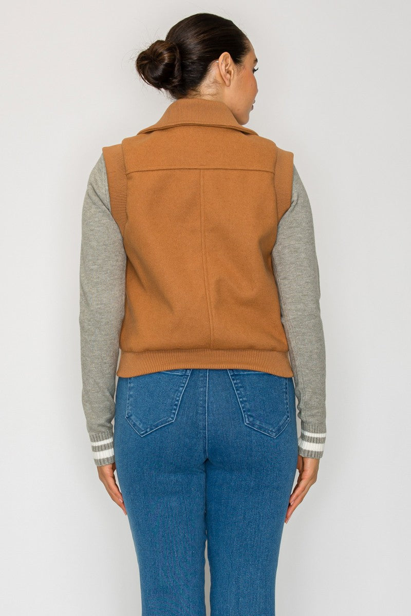 A cozy front zip knitted vest in warm brown, featuring a tailored fit and practical pockets, perfect for Long Island boutique fashion.