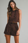 “Woman wearing brown polka dot two-piece tailored set”
