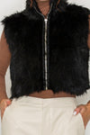 Close-up of mock neckline and plush faux fur texture on cropped vest