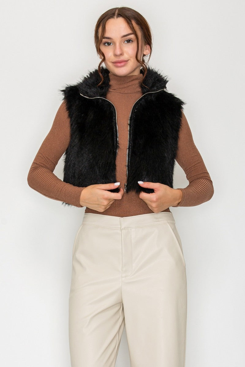 Model wearing black faux fur cropped vest jacket with zip-front closure