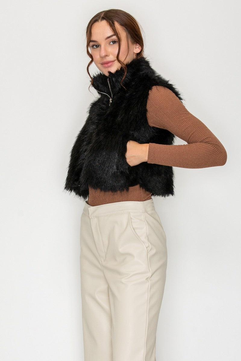 Side view of black faux fur vest showing pocket detail