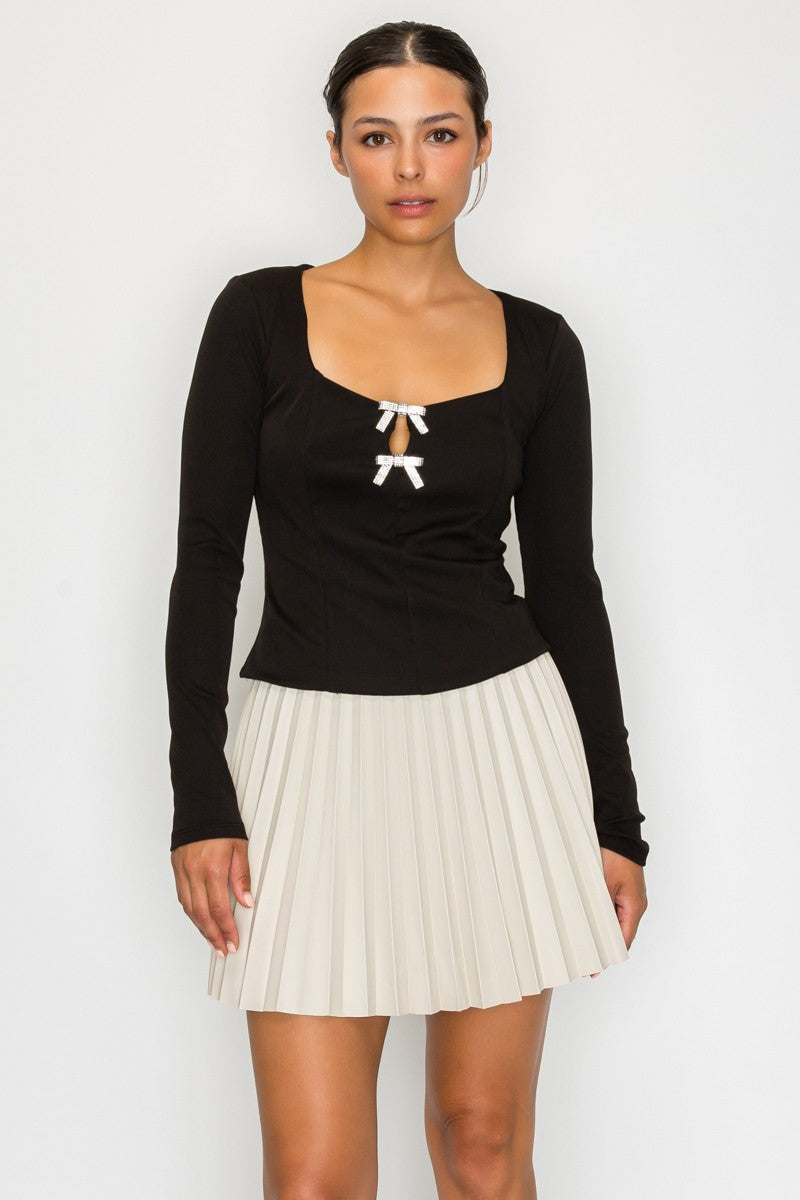 Black rhinestone bow knit top with square neckline and long sleeves – available at Off Price TandyWear