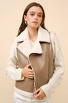 Faux leather moto vest with shearling trim in a warm taupe color, perfect for a stylish layer from a Long Island fashion boutique.