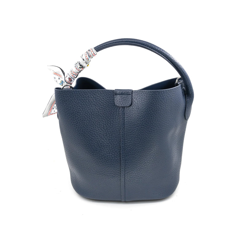 Textured navy bucket bag featuring a stylish scarf tied to the handle, perfect for chic Long Island boutique fashion.